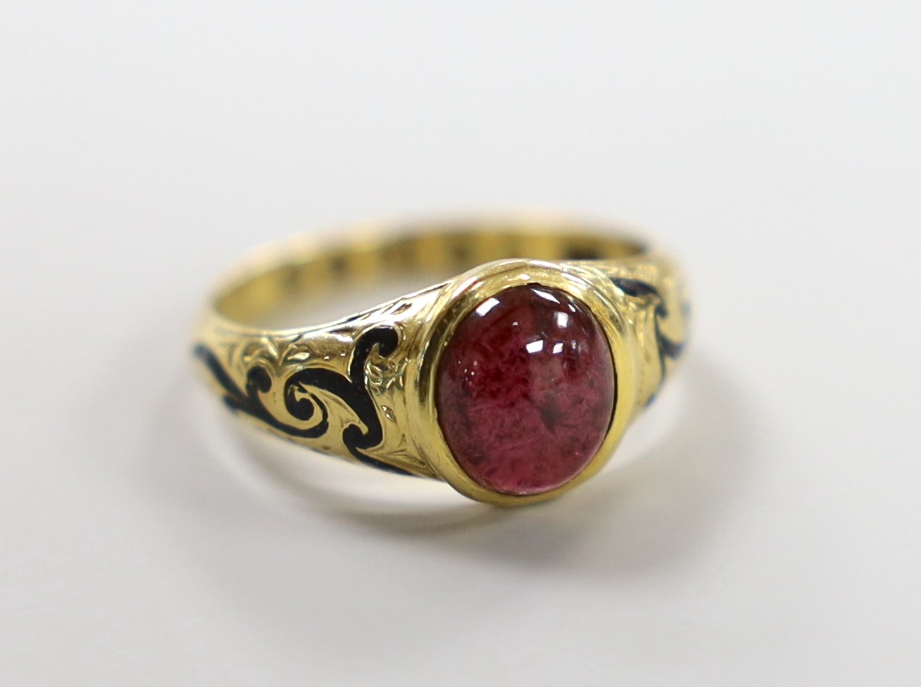 A Victorian 18ct gold, cabochon garnet and black enamel set memorial ring, the shank interior inscribed 'J W Scott obt. 26th Jan, 1851 at 41', size J, gross weight 2.8 grams.